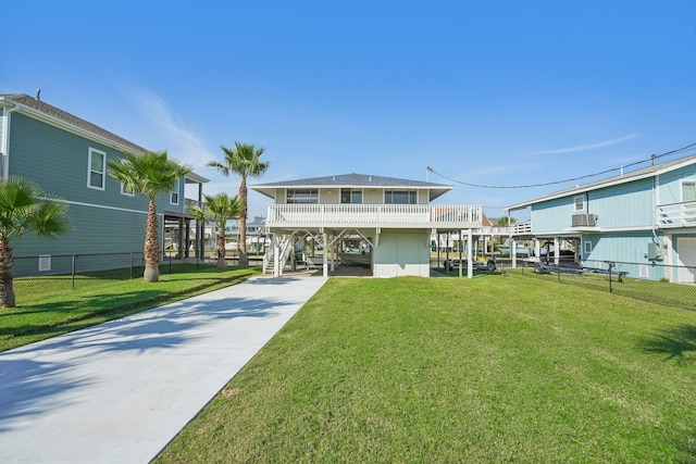 rear view of house featuring a carport and a lawn