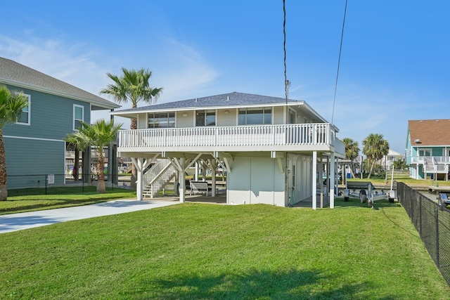 back of property with a yard and a carport