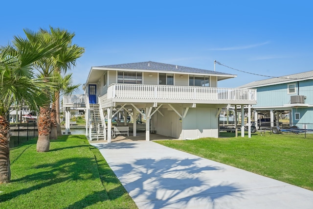 rear view of house featuring a lawn and a carport