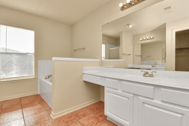 bathroom with shower with separate bathtub, vanity, and tile patterned floors