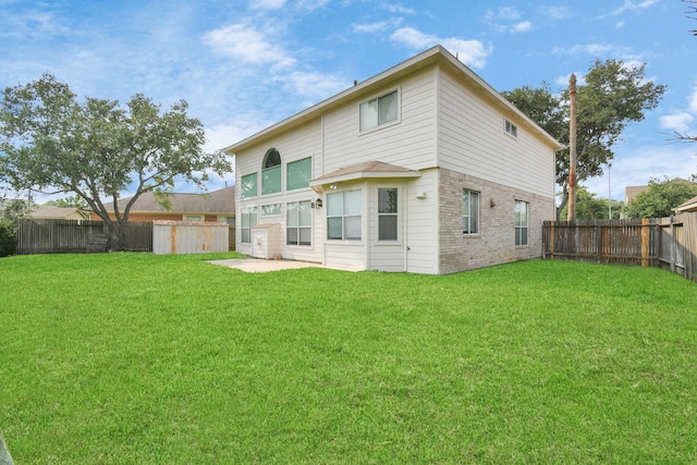 rear view of house featuring a yard and a patio area