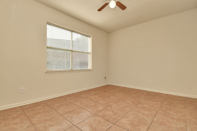 tiled spare room with ceiling fan