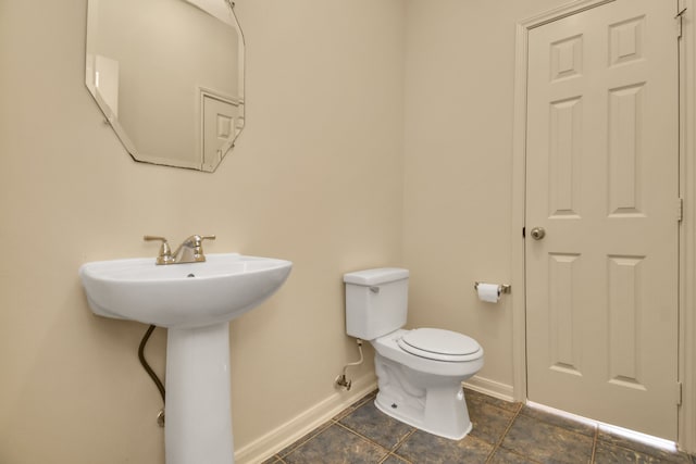 bathroom featuring tile patterned flooring and toilet