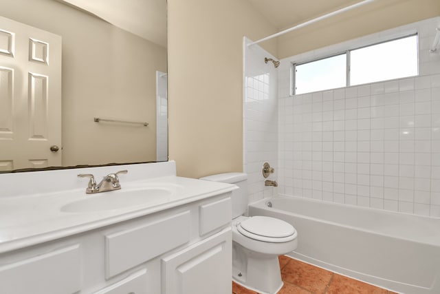 full bathroom featuring vanity, tiled shower / bath combo, and toilet