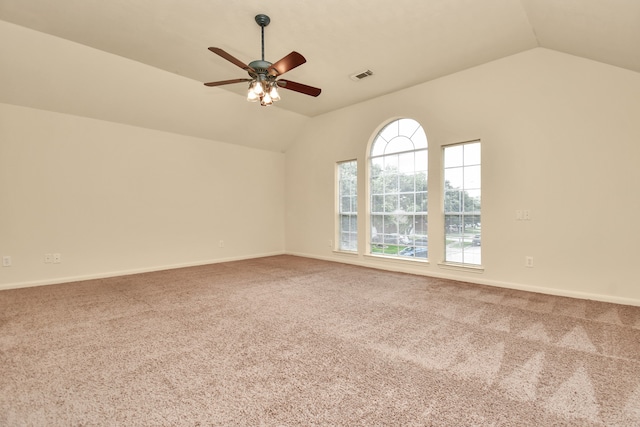 carpeted spare room featuring ceiling fan and lofted ceiling