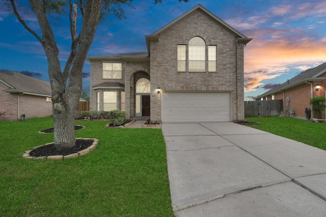 view of front of property with a yard and a garage