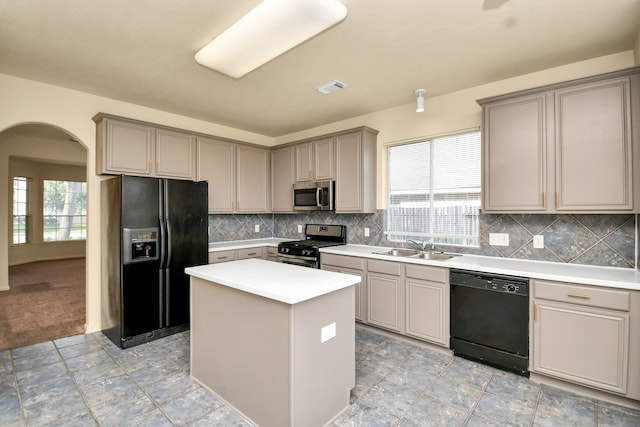 kitchen with sink, a center island, plenty of natural light, and black appliances