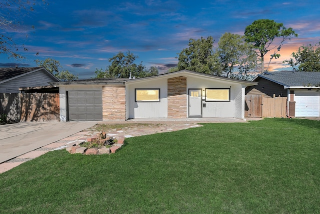 ranch-style home with a lawn and a carport