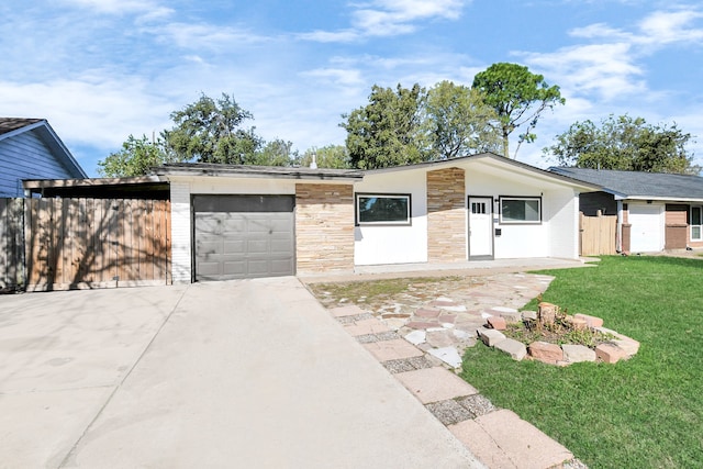 ranch-style home with a front yard, a garage, and a carport