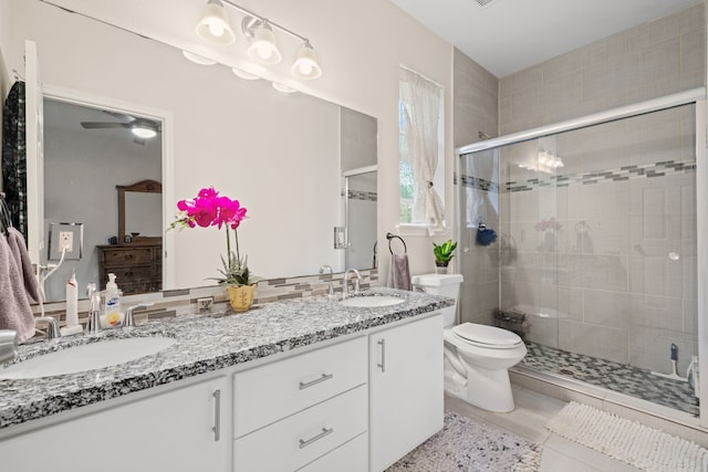 5907 Wedgefield St, Houston, TX 77028 - full bath with double vanity, a shower stall, toilet, and ceiling fan