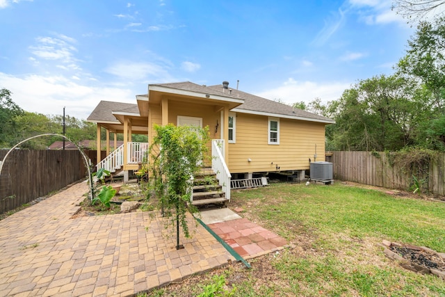 5907 Wedgefield St, Houston, TX 77028 - rear view of house with central air condition unit, a patio, and roof with shingles
