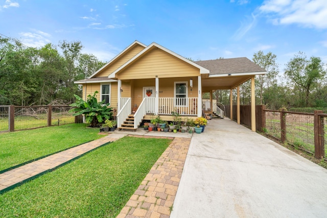 view of front of property with a front yard, a carport, and covered porch