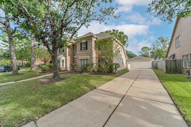 view of front of house featuring an outbuilding, a garage, and a front yard