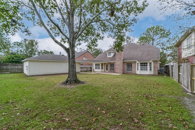 rear view of property featuring a patio area and a yard