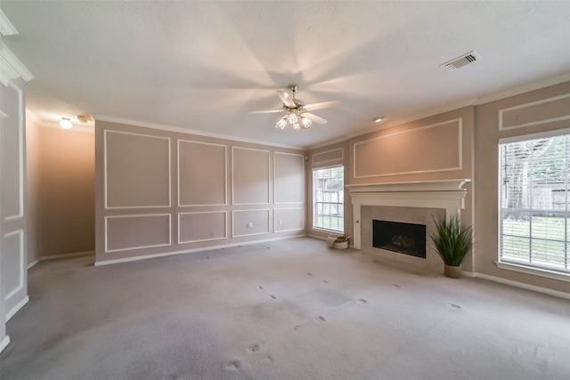 unfurnished living room with ceiling fan, light colored carpet, and a healthy amount of sunlight