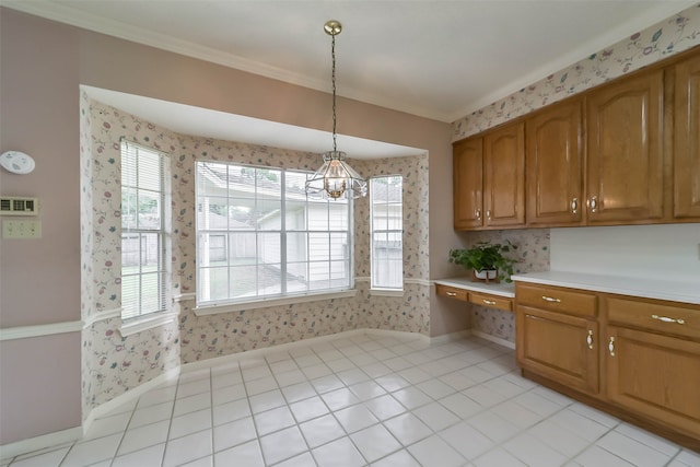 kitchen featuring pendant lighting, a notable chandelier, light tile patterned floors, and crown molding