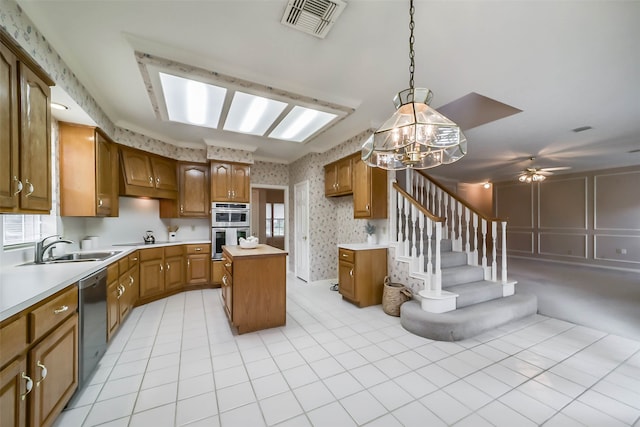 kitchen featuring a center island, ceiling fan with notable chandelier, sink, light tile patterned floors, and stainless steel appliances