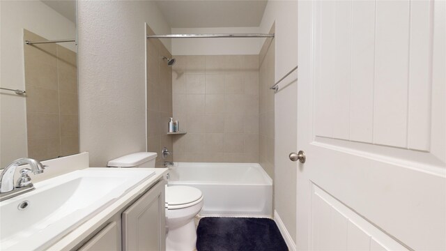 full bathroom featuring vanity, toilet, and tiled shower / bath