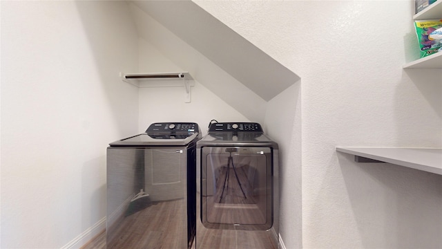 laundry area featuring hardwood / wood-style flooring and washing machine and clothes dryer