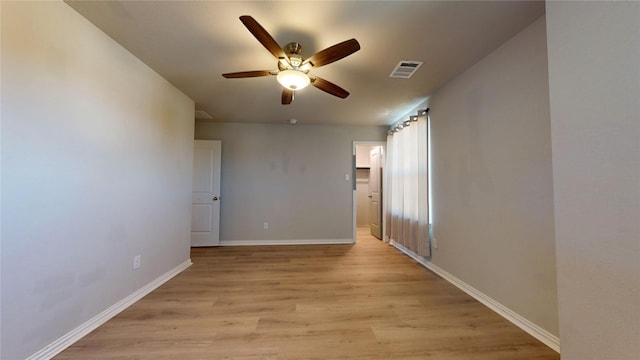 empty room featuring light hardwood / wood-style floors and ceiling fan