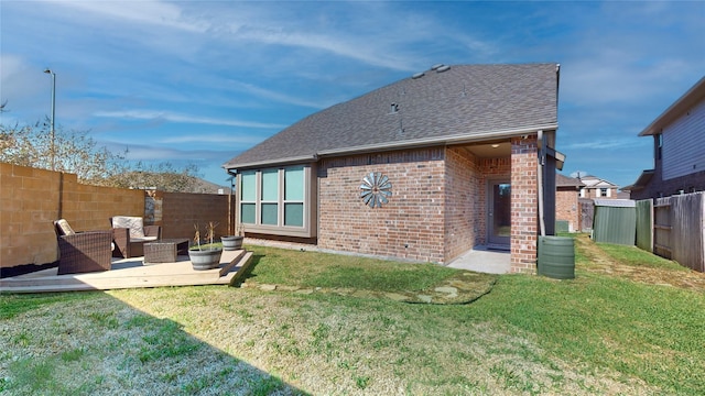 rear view of house featuring a yard and an outdoor living space