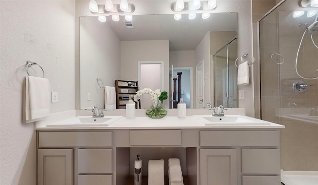 bathroom featuring vanity and a shower with shower door