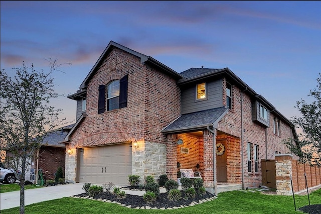 view of property featuring a garage and a yard