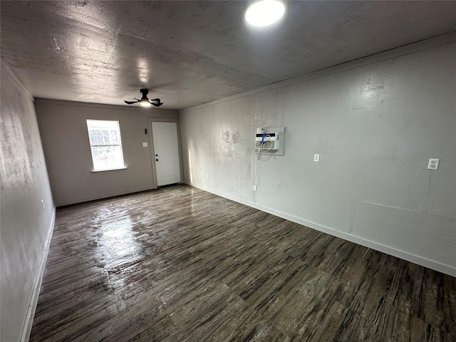 spare room with ceiling fan, a wall mounted air conditioner, and dark hardwood / wood-style floors