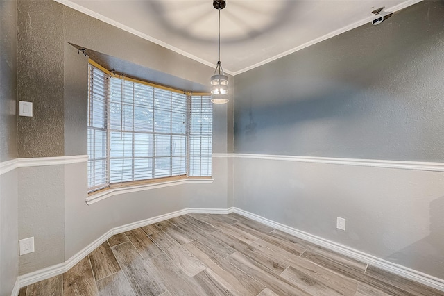 unfurnished dining area featuring wood-type flooring and ornamental molding