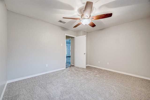 carpeted empty room featuring ceiling fan