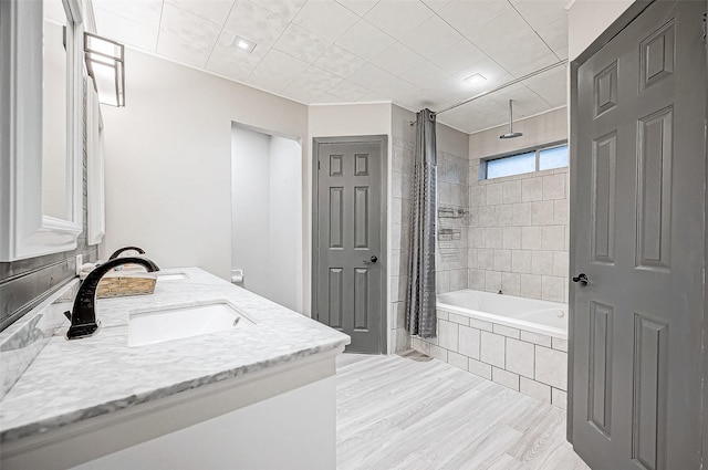 bathroom featuring shower / bath combo with shower curtain and vanity