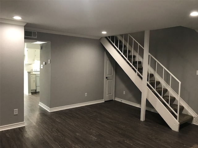 unfurnished living room featuring dark hardwood / wood-style floors and crown molding