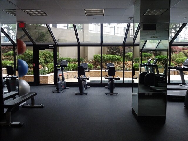 gym with floor to ceiling windows and plenty of natural light