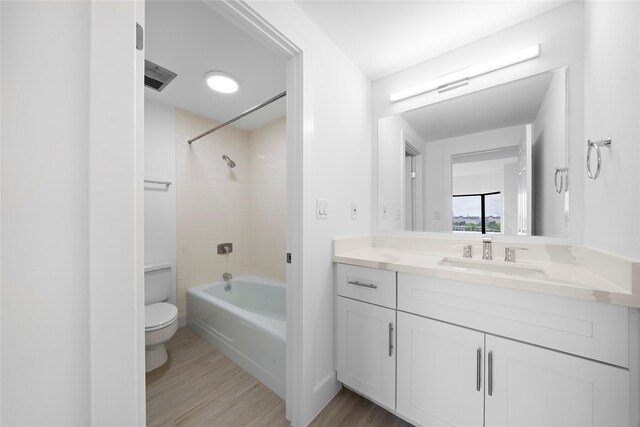 2001 Holcombe Blvd Unit 705, Houston, TX 77030 - bathroom featuring toilet, wood finished floors, vanity, and tub / shower combination