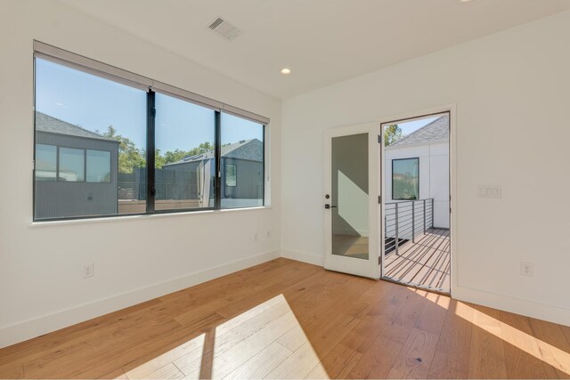 unfurnished room with wood-type flooring