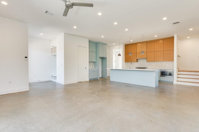 unfurnished living room with ceiling fan