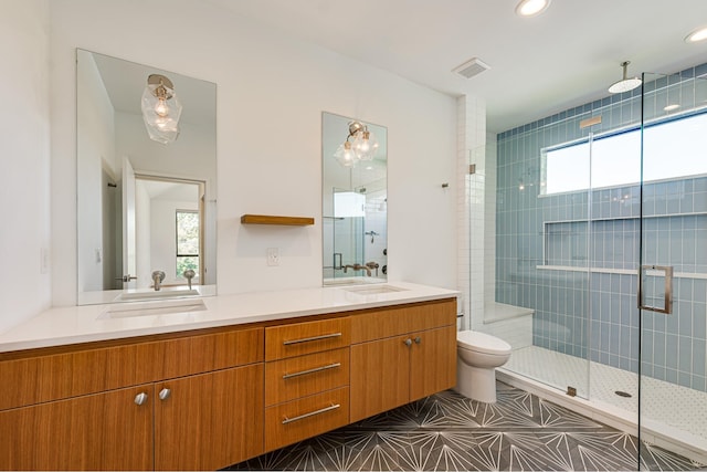 bathroom featuring plenty of natural light, an enclosed shower, and toilet