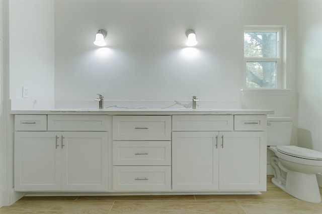 bathroom featuring vanity and toilet