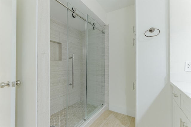 bathroom featuring an enclosed shower and vanity