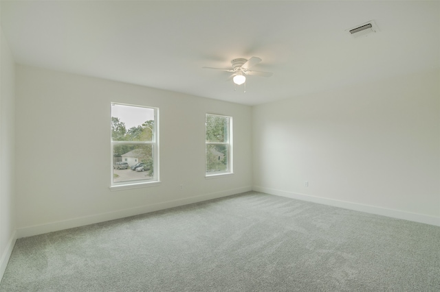 empty room with ceiling fan and carpet floors