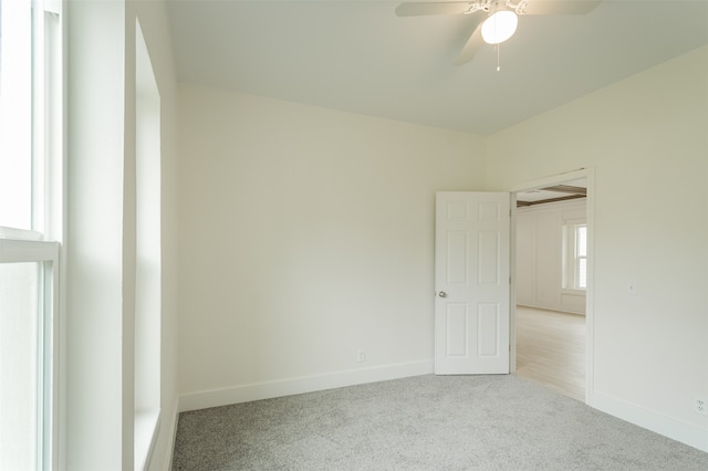 carpeted empty room featuring ceiling fan