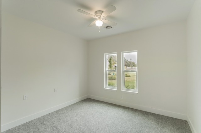 unfurnished room featuring ceiling fan and carpet