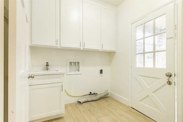 washroom with cabinets, sink, and washer hookup