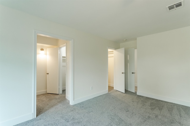 unfurnished bedroom featuring light colored carpet