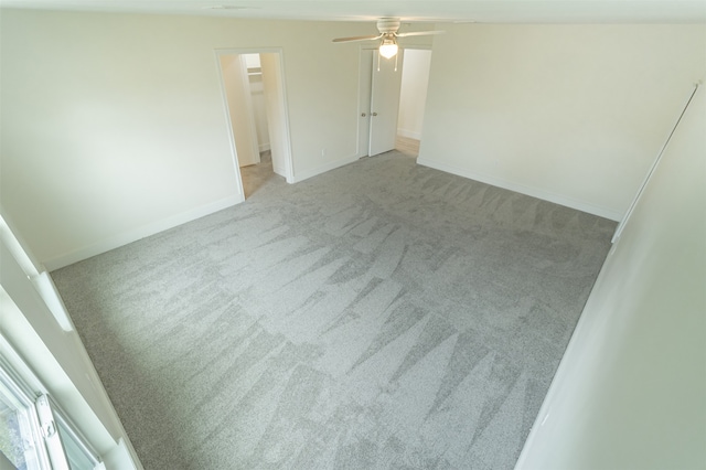 empty room with light colored carpet and ceiling fan