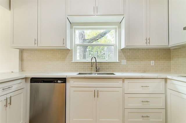 kitchen featuring sink, decorative backsplash, stainless steel dishwasher, and white cabinets