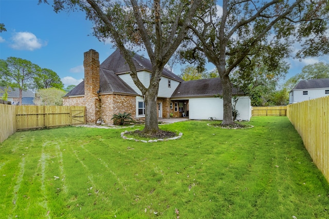 back of house with a yard