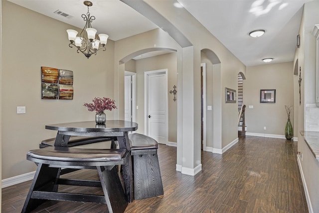 729 Pegasus Ln, League City, TX 77573 - dining area with arched walkways, visible vents, dark wood-style flooring, and an inviting chandelier