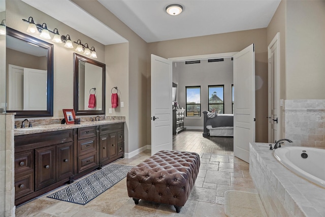 bathroom with vanity and tiled bath