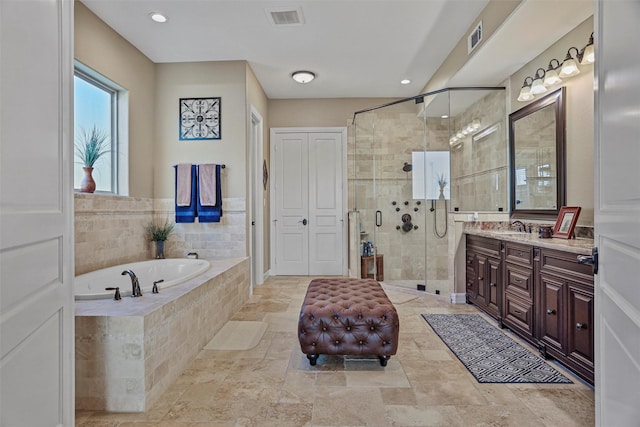 bathroom featuring vanity and separate shower and tub